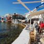 Quaint hotels, restaurants and tourists dot the waterfront of Mykonos.